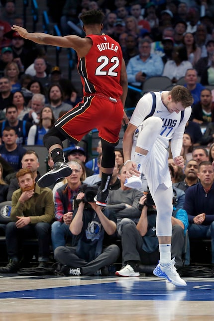 Dallas Mavericks forward Luka Doncic (77) reacts after injuring himself as Miami Heat...