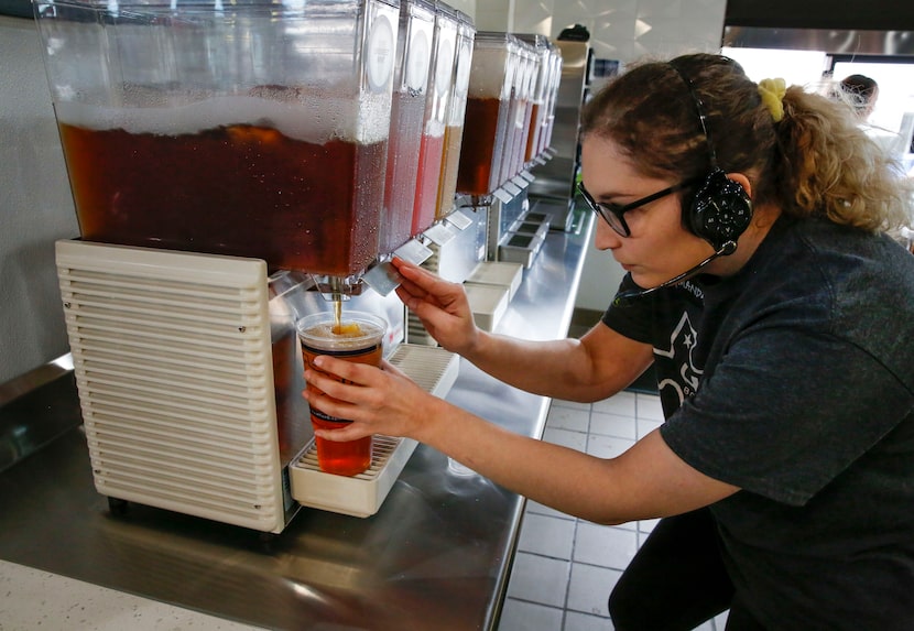 HTeaO associate Amanda Braswell fixes a drink order for the drive-through window in Carrollton.