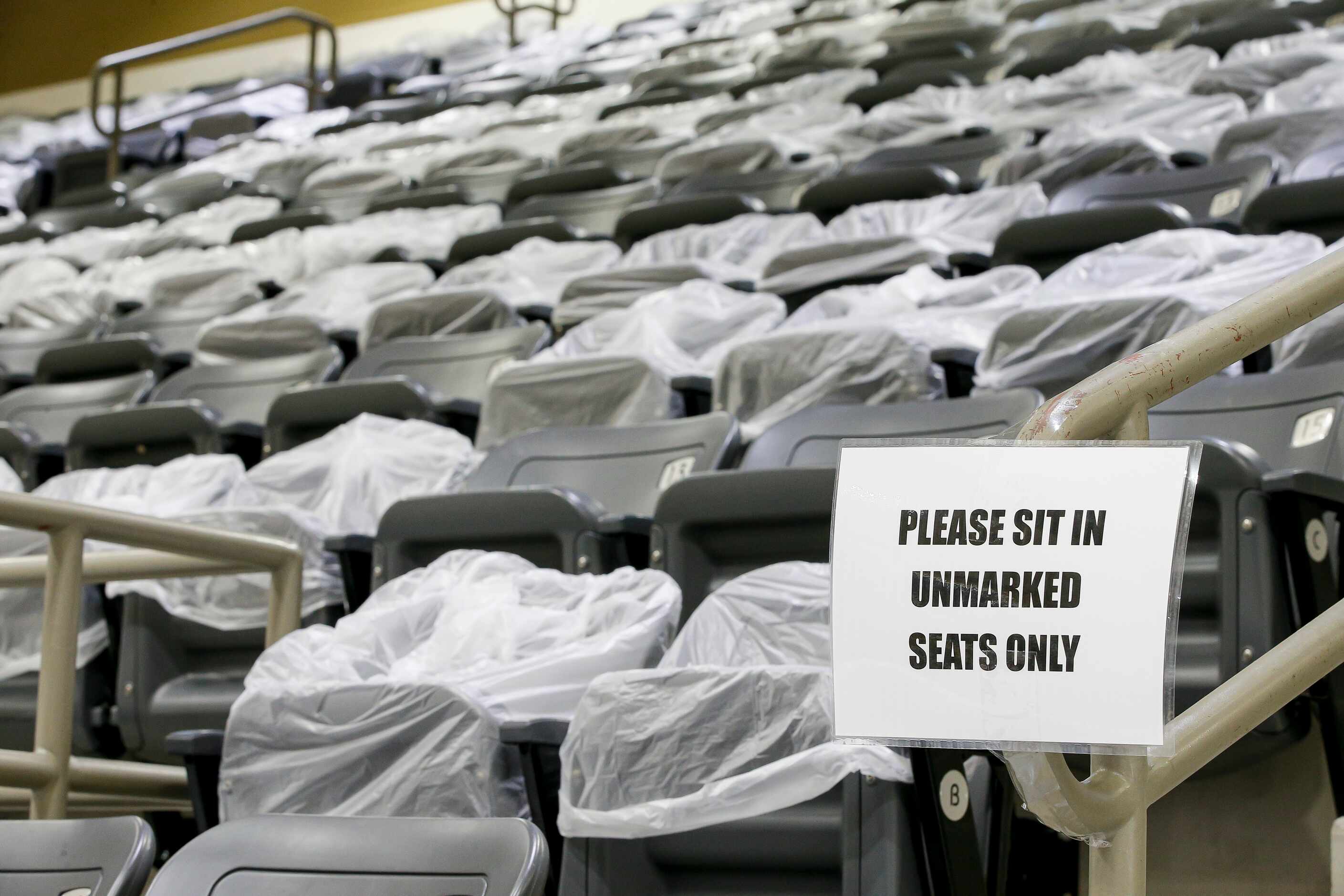 Seats are blocked off with plastic bags to enforce social distancing rules during a...
