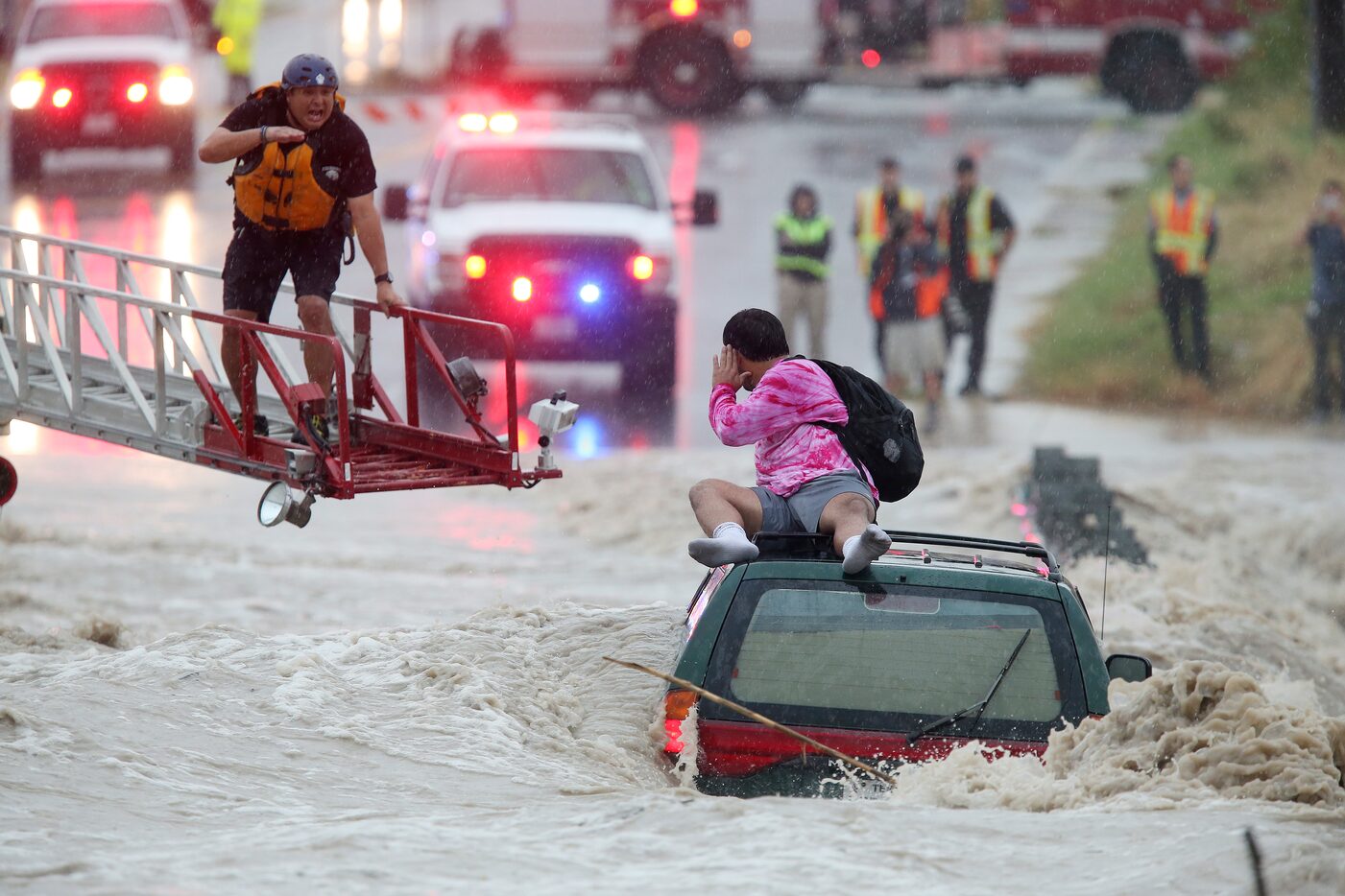 San Antonio Fire Department personnel rescued a man trapped Monday on top of his submerged...