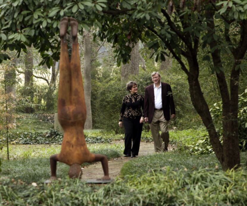 Cheryl and Kevin Vogel take a walk through the sculpture garden. The sculpture (left) is...