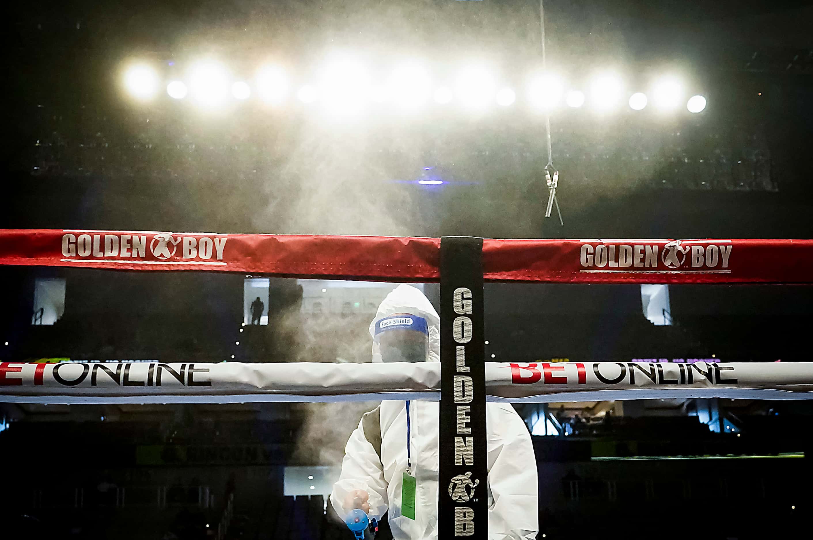 Crews disinfect the ring after Hector Valdez defeated Alberto Torres in a super bantamweight...