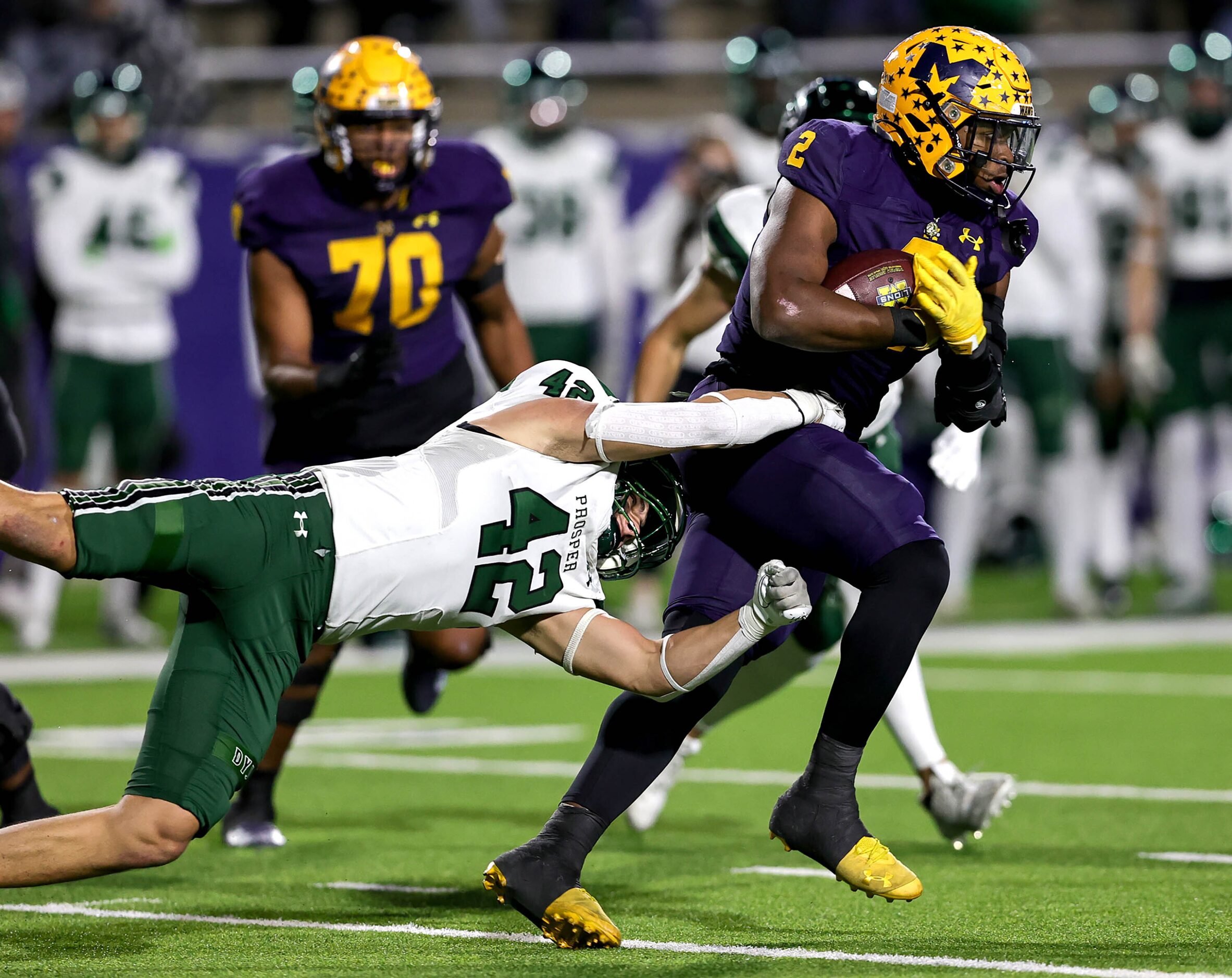 McKinney running back Bryan Jackson (2) tries to break free from Prosper linebacker Cade...