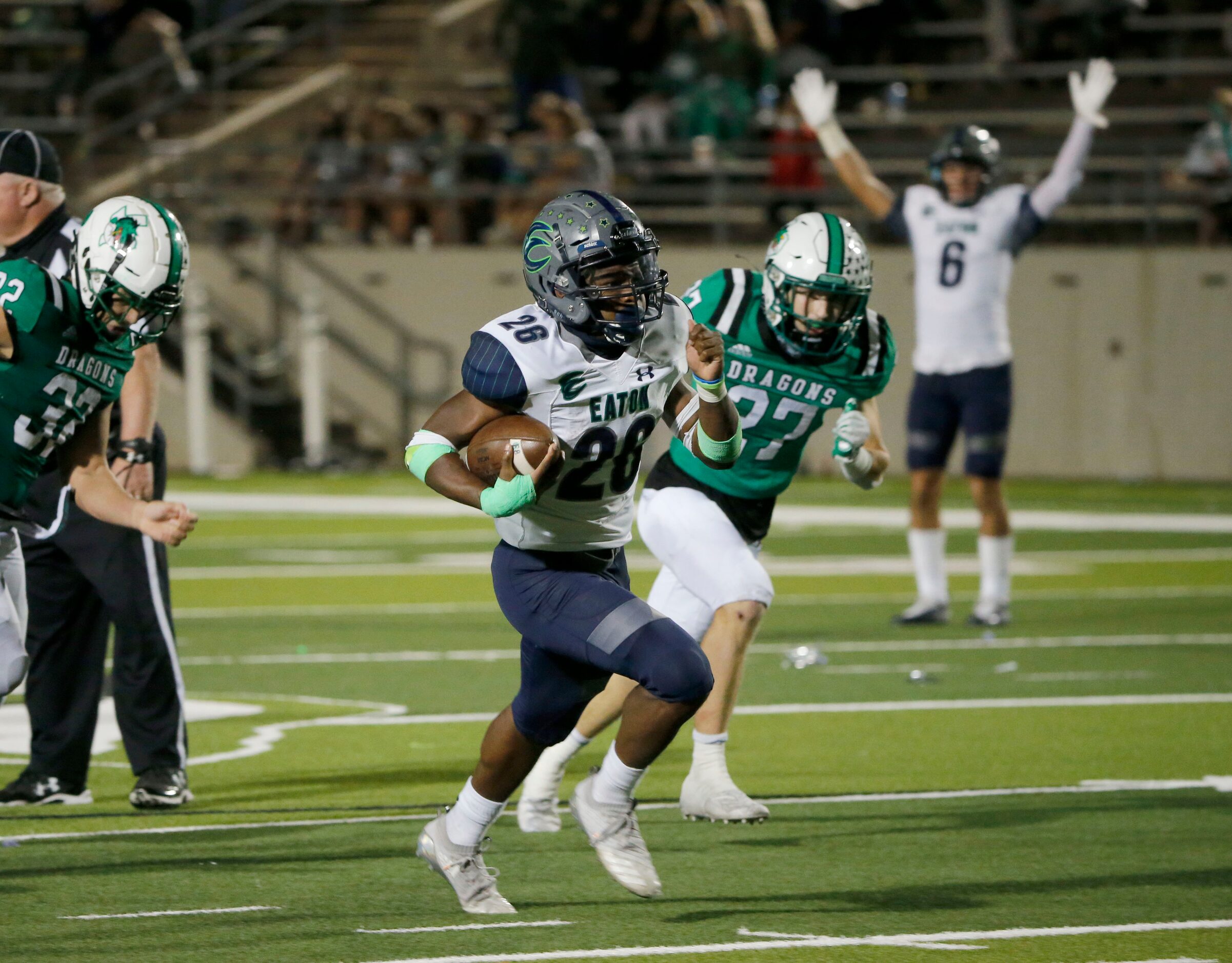 Eaton running back Isaac Jones (26) runs past Southlake’s Mason Grawe (27) during their high...