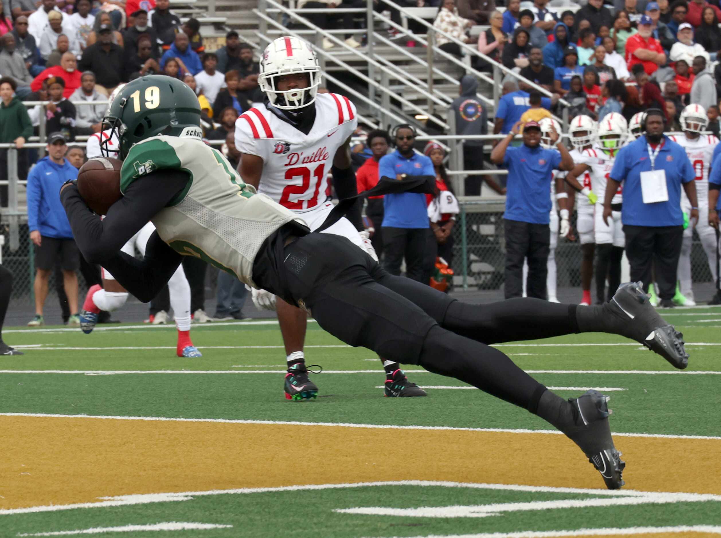 DeSoto receiver Kristoff Fantroy (19) lunges to pull in a touchdown pass in the end zone as...