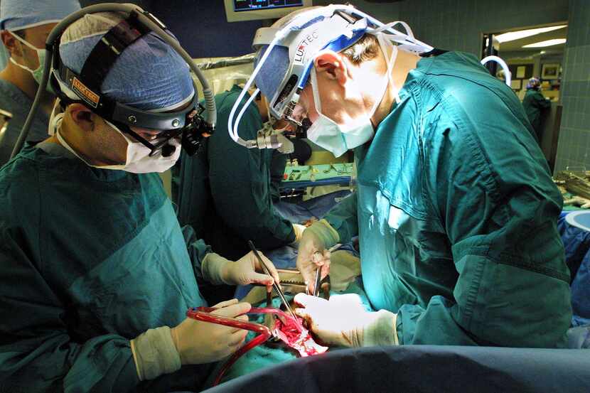 Dr. O. H. 'Bud' Frazier (right) works on a double-bypass heart surgery at St. Luke's...