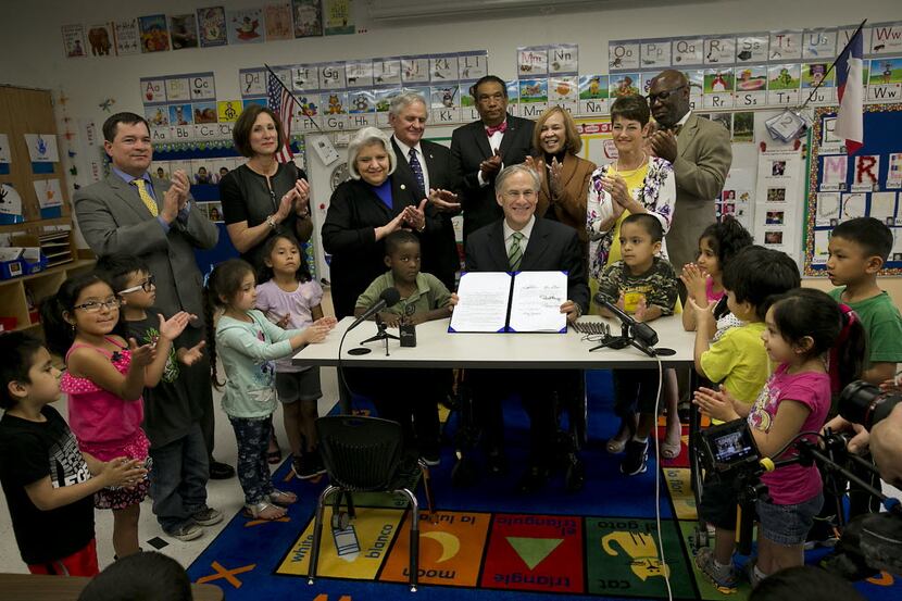 Texas Gov. Greg Abbott poses for a photo after signing into law a pre-K boost that was among...