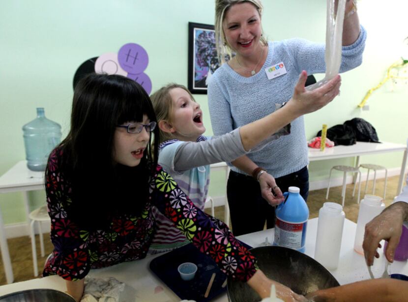 River Morin (left), 7,  and Elise Thornton, 6, played with slime during an after school...