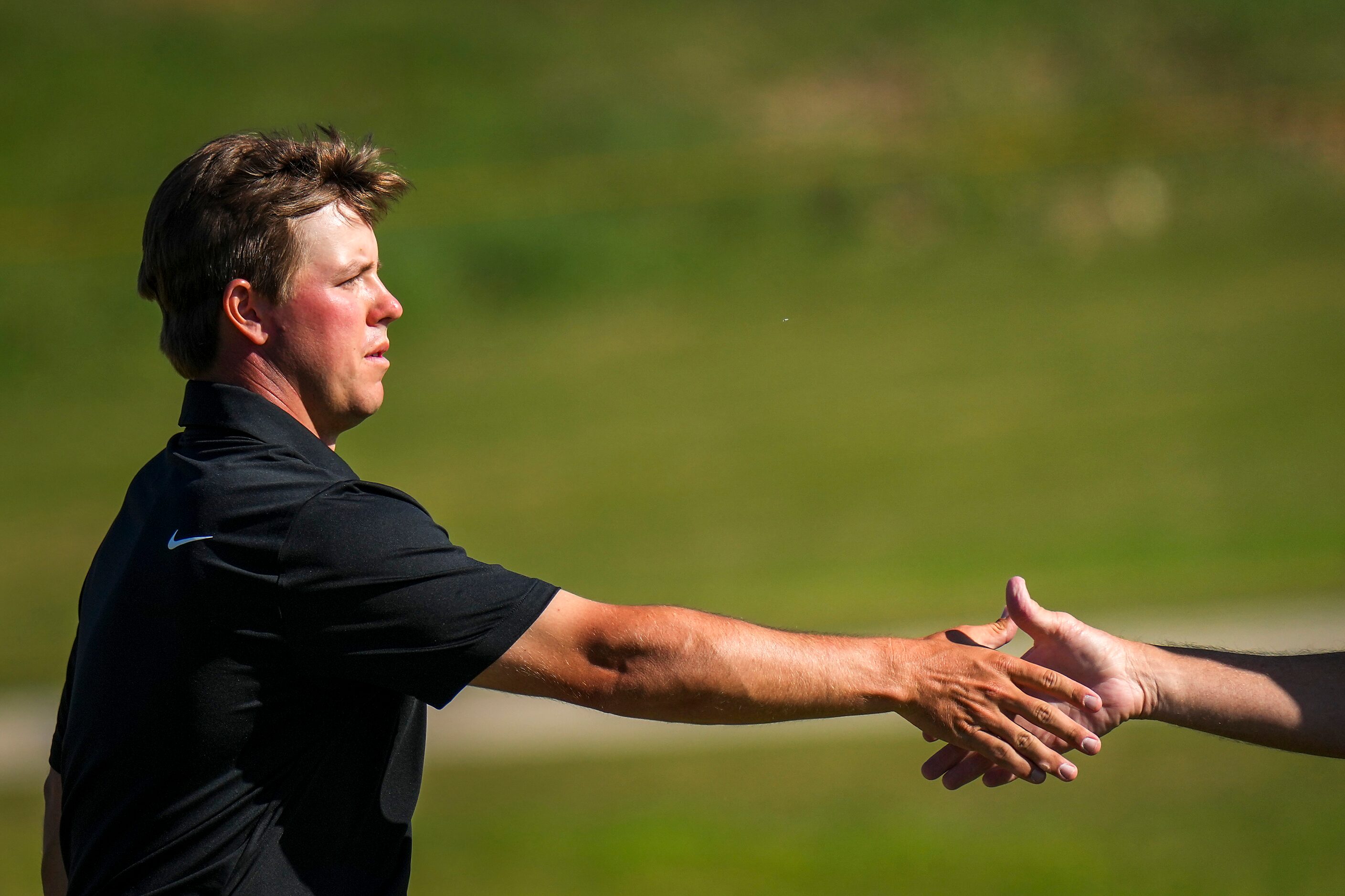 Parker Coody shakes hands with a playing partner after completing final round of the Korn...