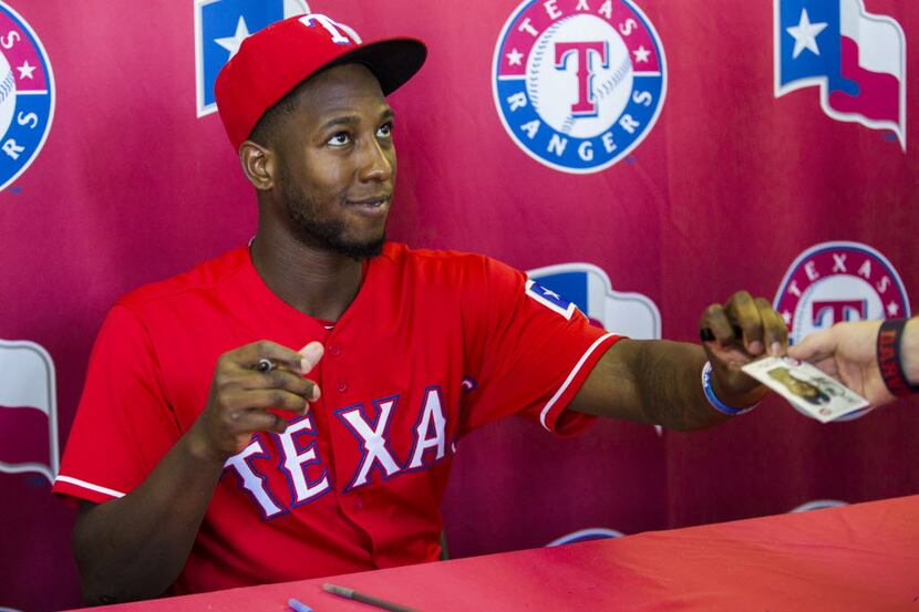 Texas Rangers infielder Jurickson Profar (19) signs autographs in the outfield concourse...