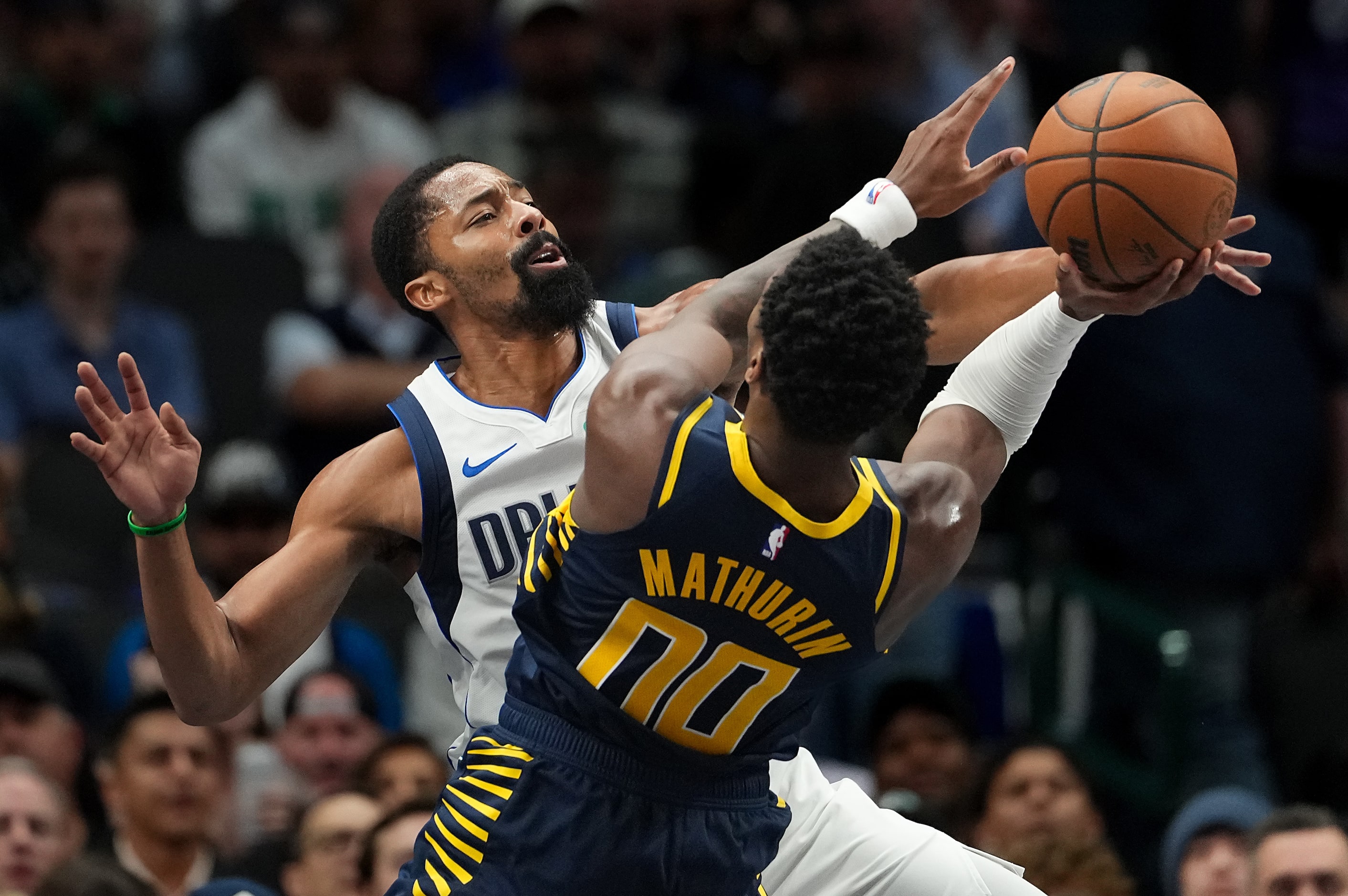 Dallas Mavericks guard Spencer Dinwiddie (26) fouls Indiana Pacers guard Bennedict Mathurin...