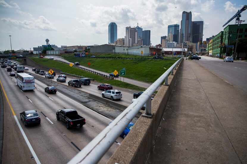 Vehicles make their way west on Interstate 30 under the S Harwood Street bridge, south of...