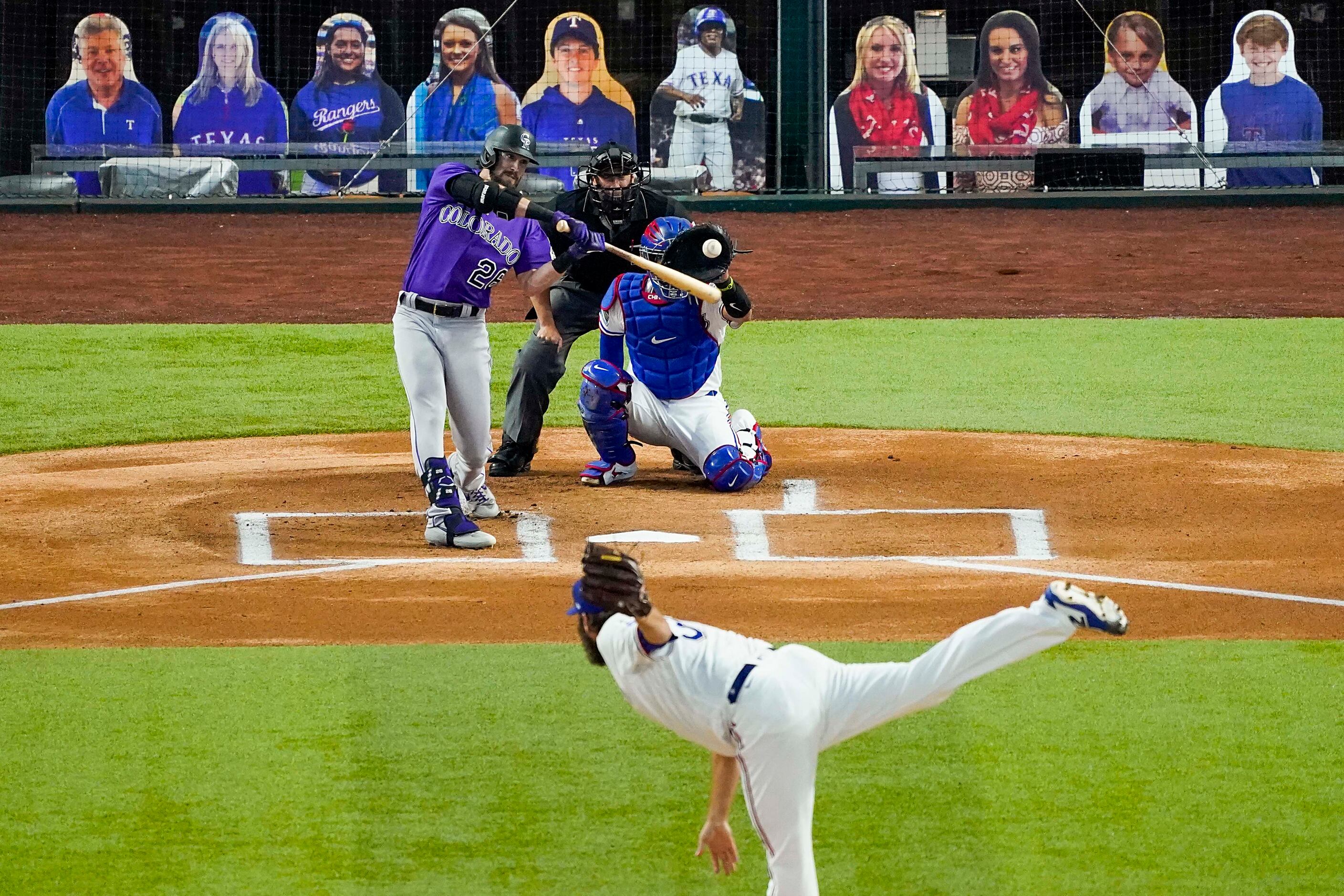 Colorado Rockies center fielder David Dahl strikes out on a pitch from Texas Rangers pitcher...