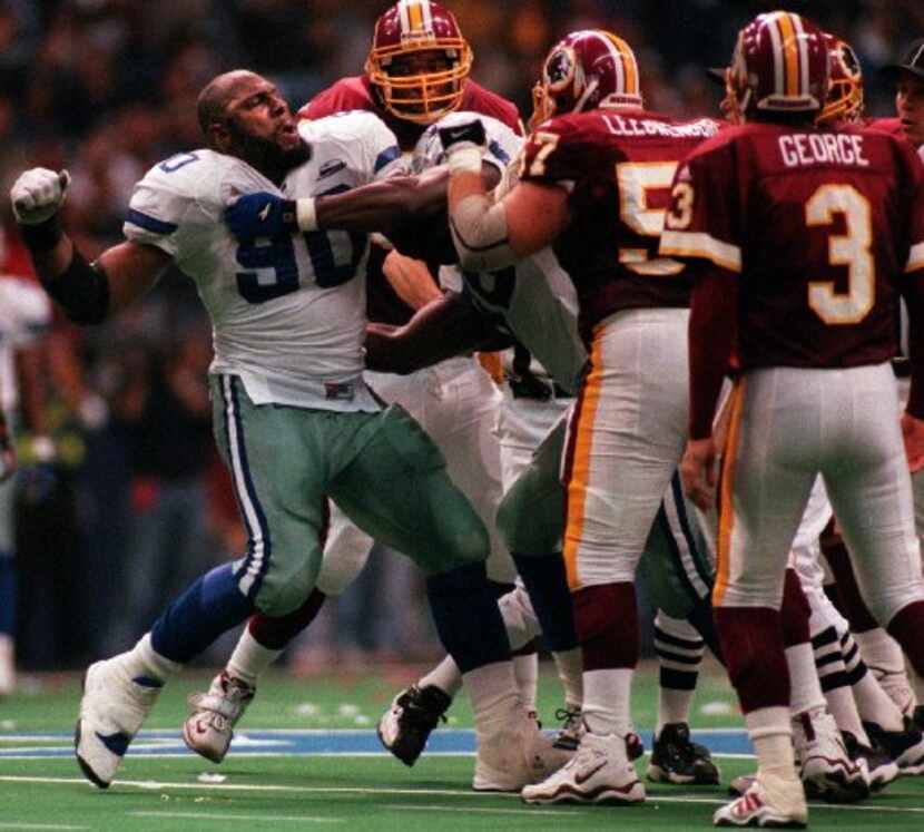 Dallas Cowboys' defensive lineman Alonzo Spellman (90) throws a punch at Redskins' Jay...