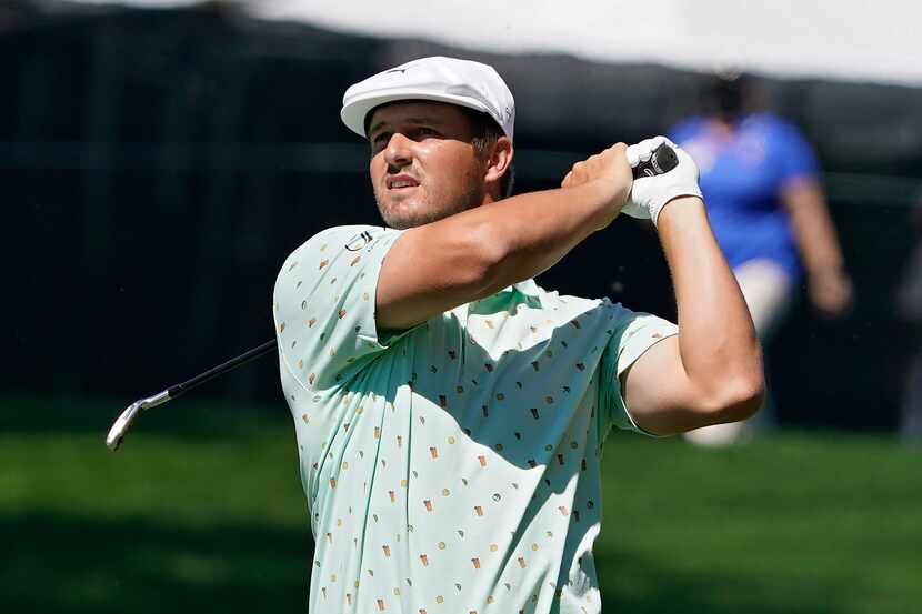 Bryson DeChambeau hits from the fairway on the ninth hole during the first round of the...