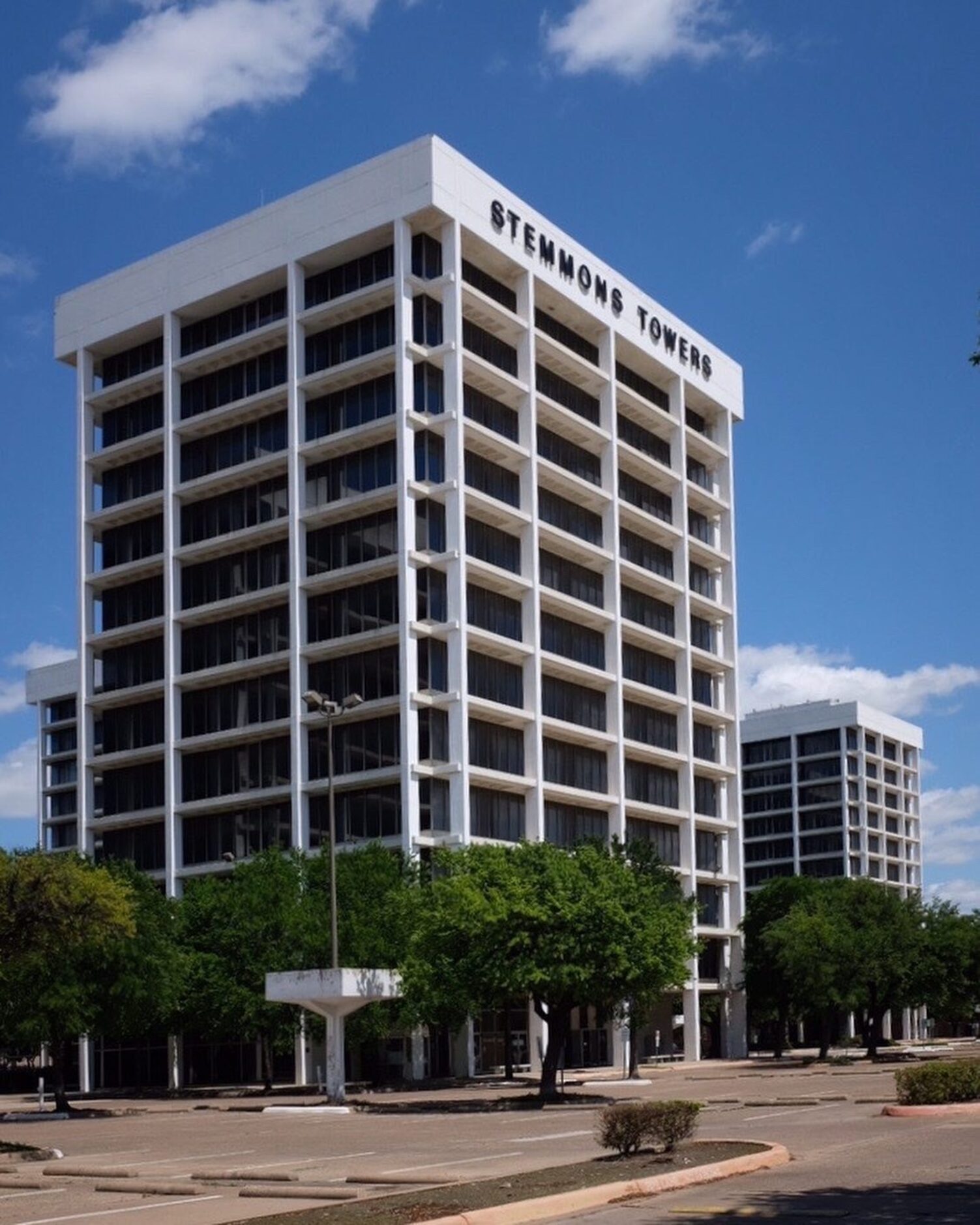 The Stemmons Towers complex, a campus of crisp towers defined by their exposed concrete...