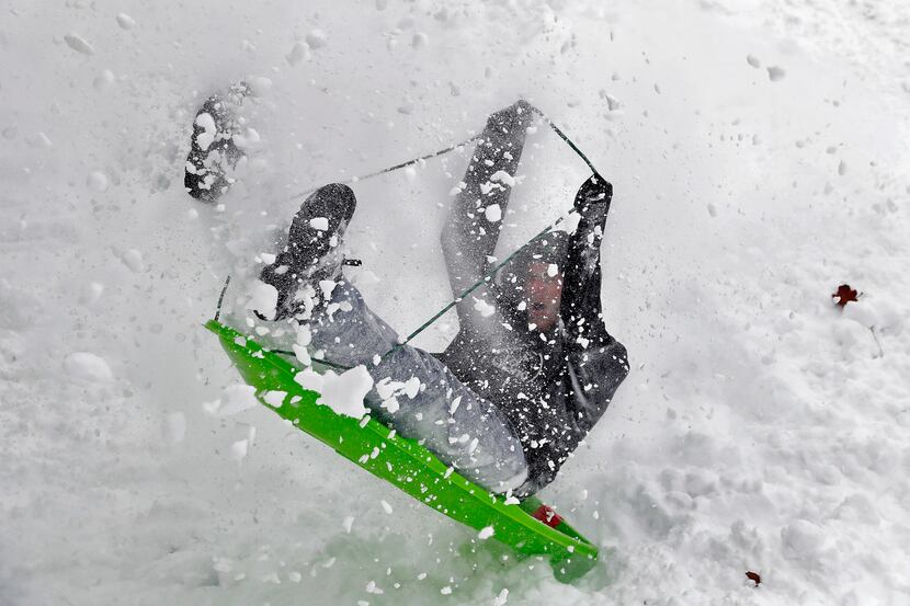 HAMPTON, VA: Dillon Utter loses control of his sled while sliding down a hill on Fort Monroe...