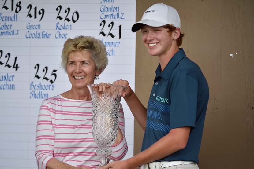 Peggy Nelson holds the Byron Nelson Junior Championship trophy with winner Ryan Grider at...