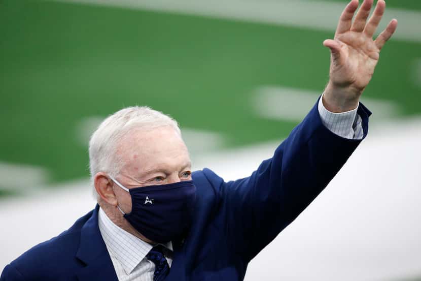 Cowboys owner and general manager Jerry Jones waves to the crowd during warmups before a...