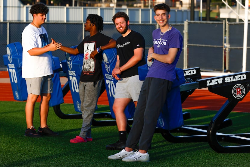 L.D. Bell High School football players Matthew Hernandez and Michael Woods, from left, dap...