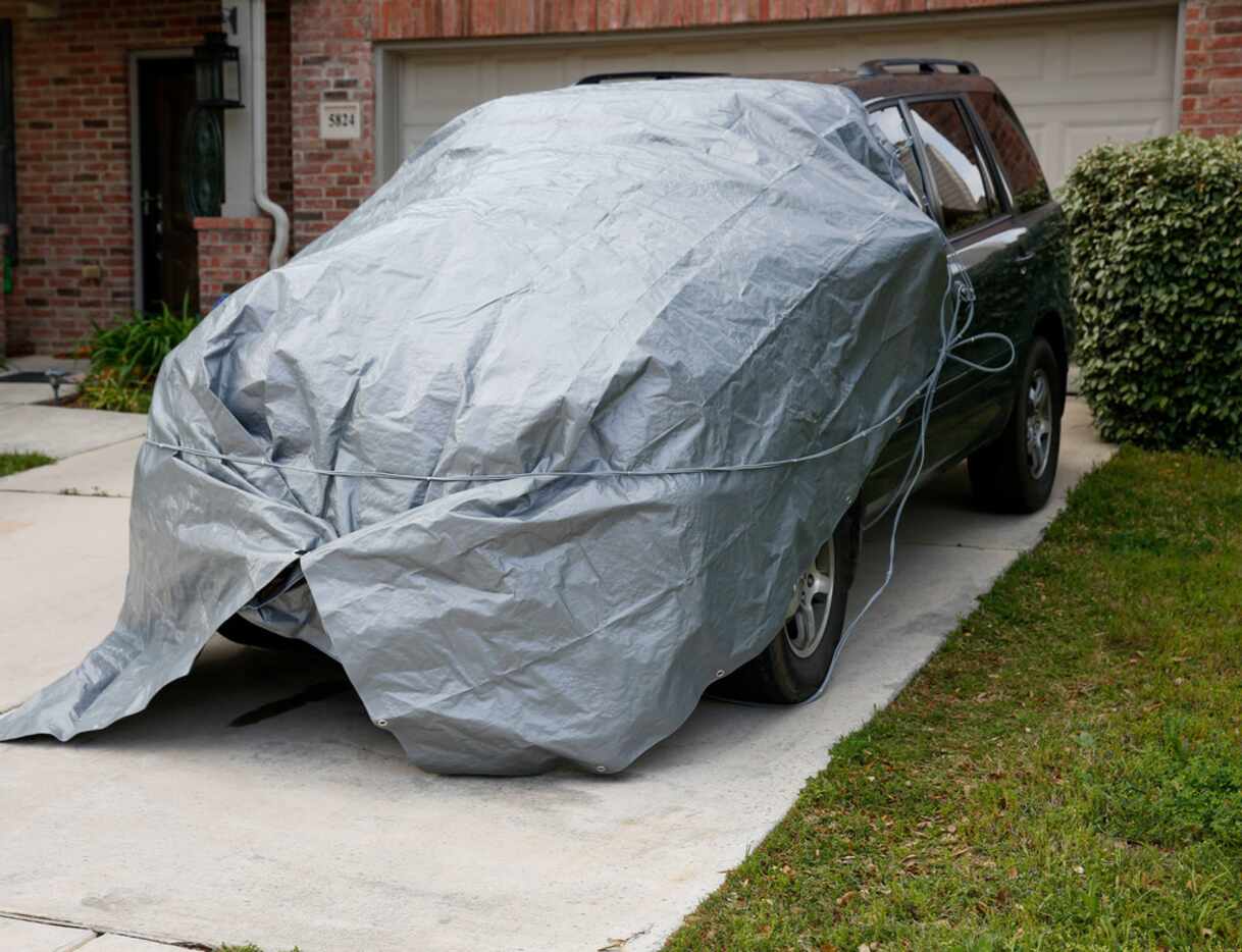 Residents in McKinney prepare their cars for possible hail  as the threat of storms get...