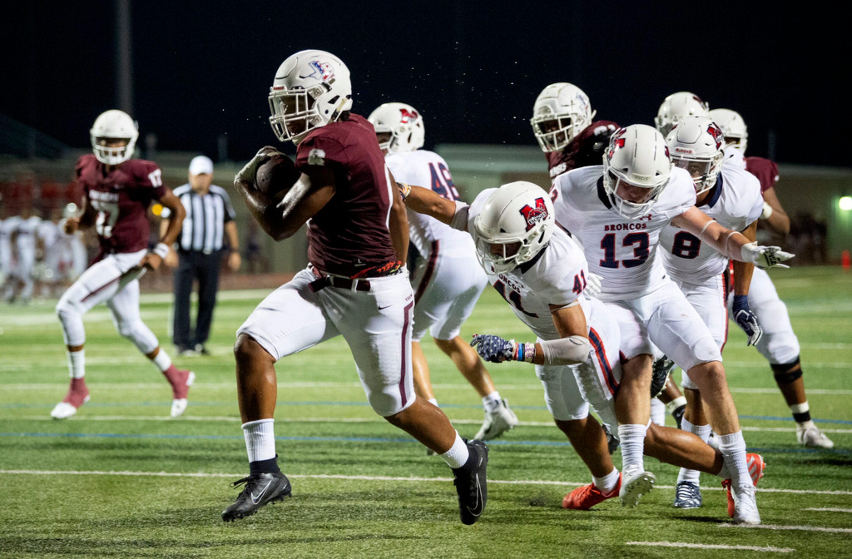 Lewisville sophomore running back Damien Martinez (6) breaks through McKinney Boyd senior...