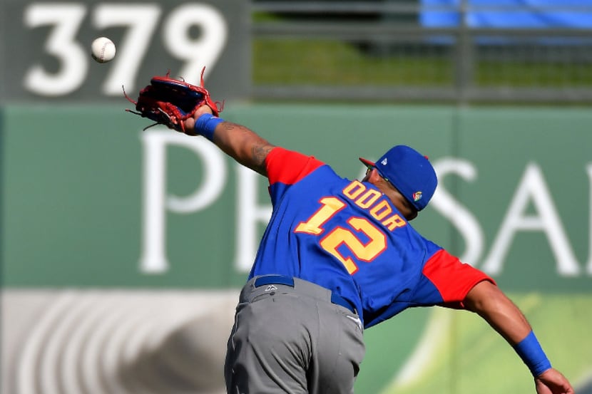 Venezuela second baseman Rougned Odor deflects a single by Kansas City Royals' Humberto...