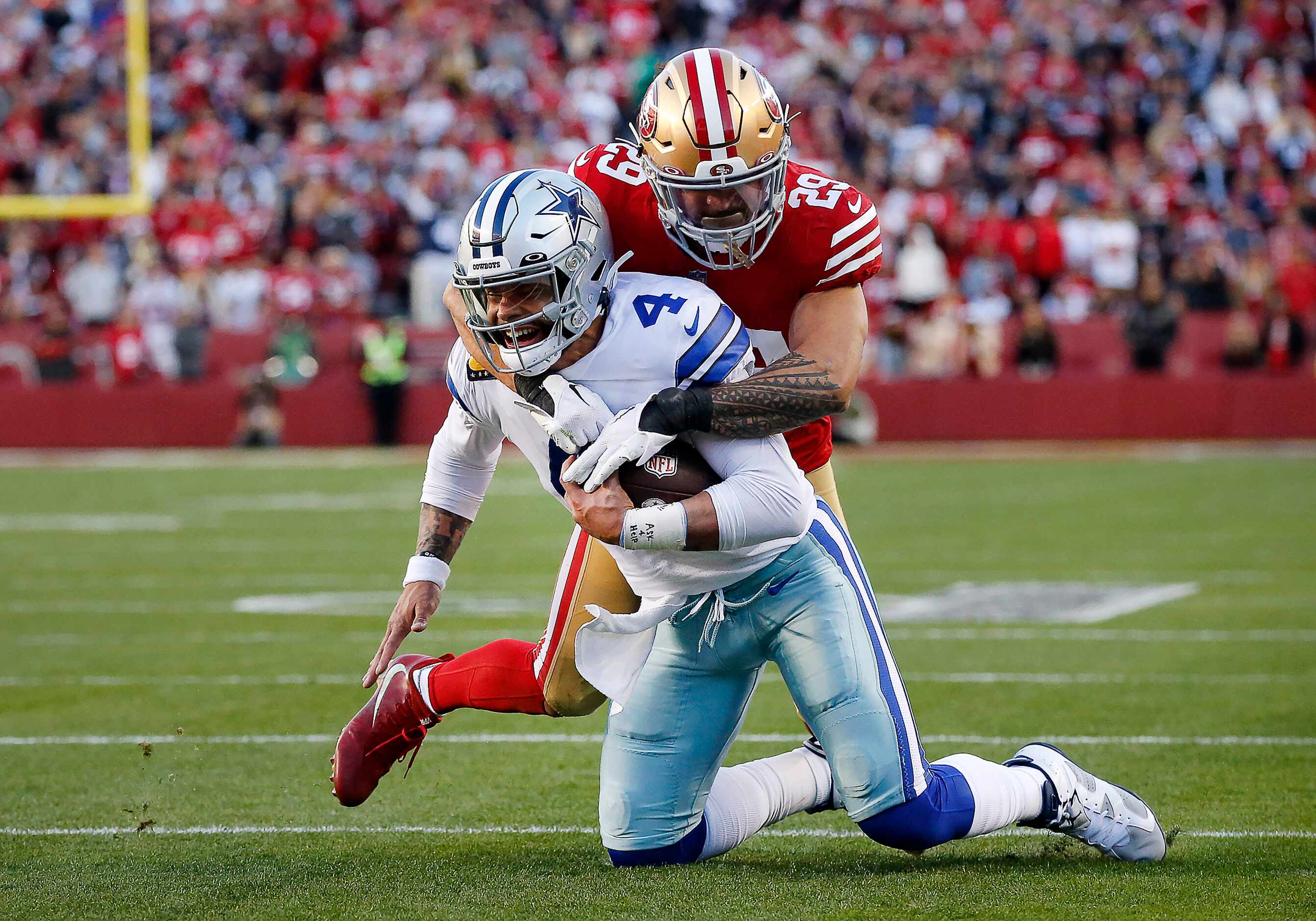 Dallas Cowboys quarterback Dak Prescott (4) is tackled by San Francisco 49ers safety Talanoa...