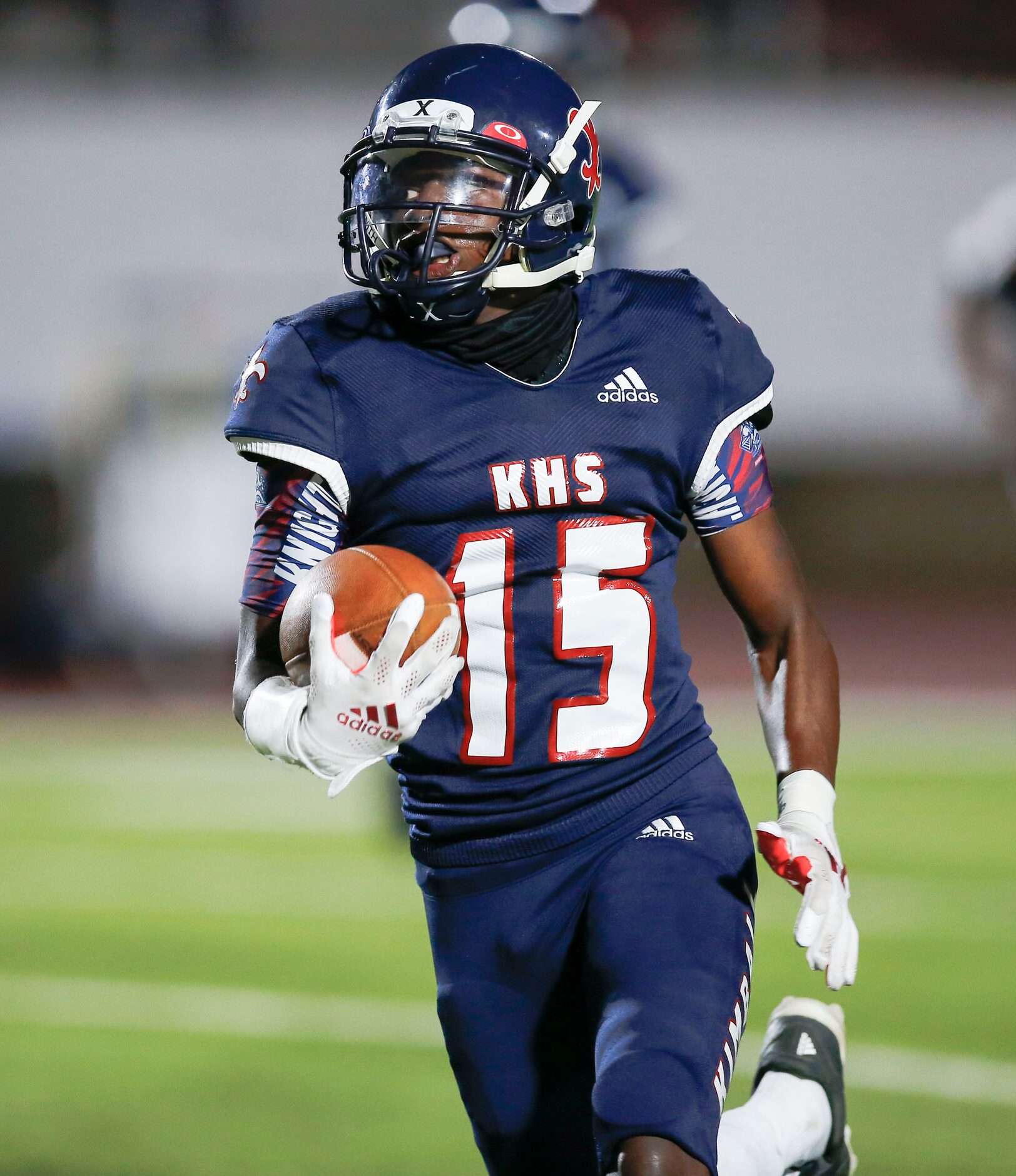 Kimball junior wide receiver Cedric Robertson carries the ball during the first half of a...