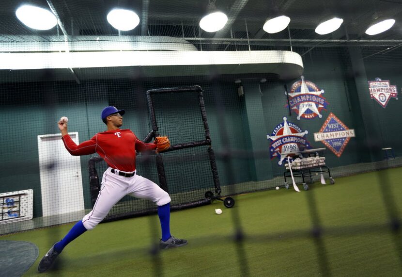 Pitcher Dillon Tate throws in their indoor workout area  of Globe Life Park in Arlington...