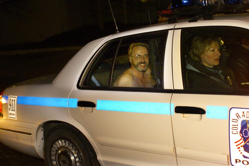 Texas prison escapee Patrick Murphy Jr. smiles from the back seat of a Colorado Springs...