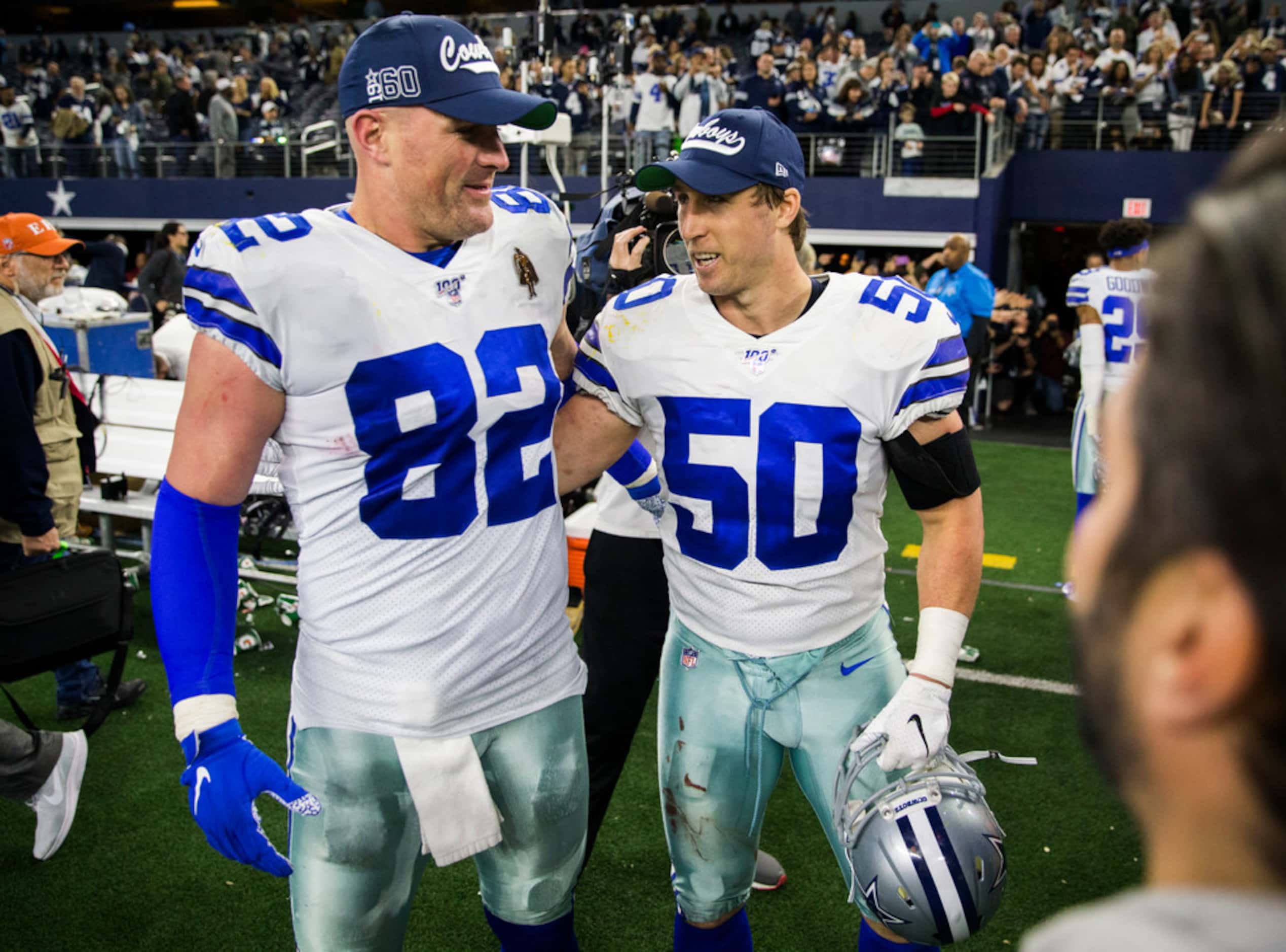 Dallas Cowboys tight end Jason Witten (82) and outside linebacker Sean Lee (50) hug after an...