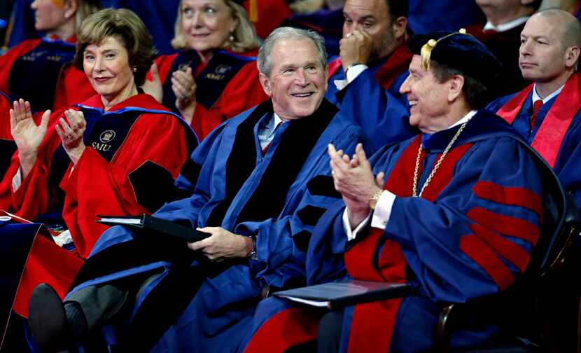 President George W. Bush (center) smiles as he is introduced to the crowd during the SMU May...