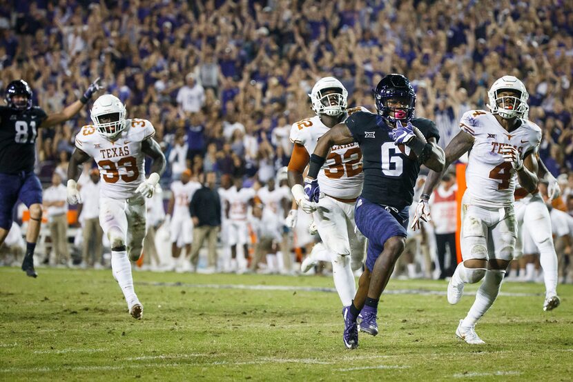 TCU running back Darius Anderson (6) breaks through the Texas defense to score on a 31-yard...