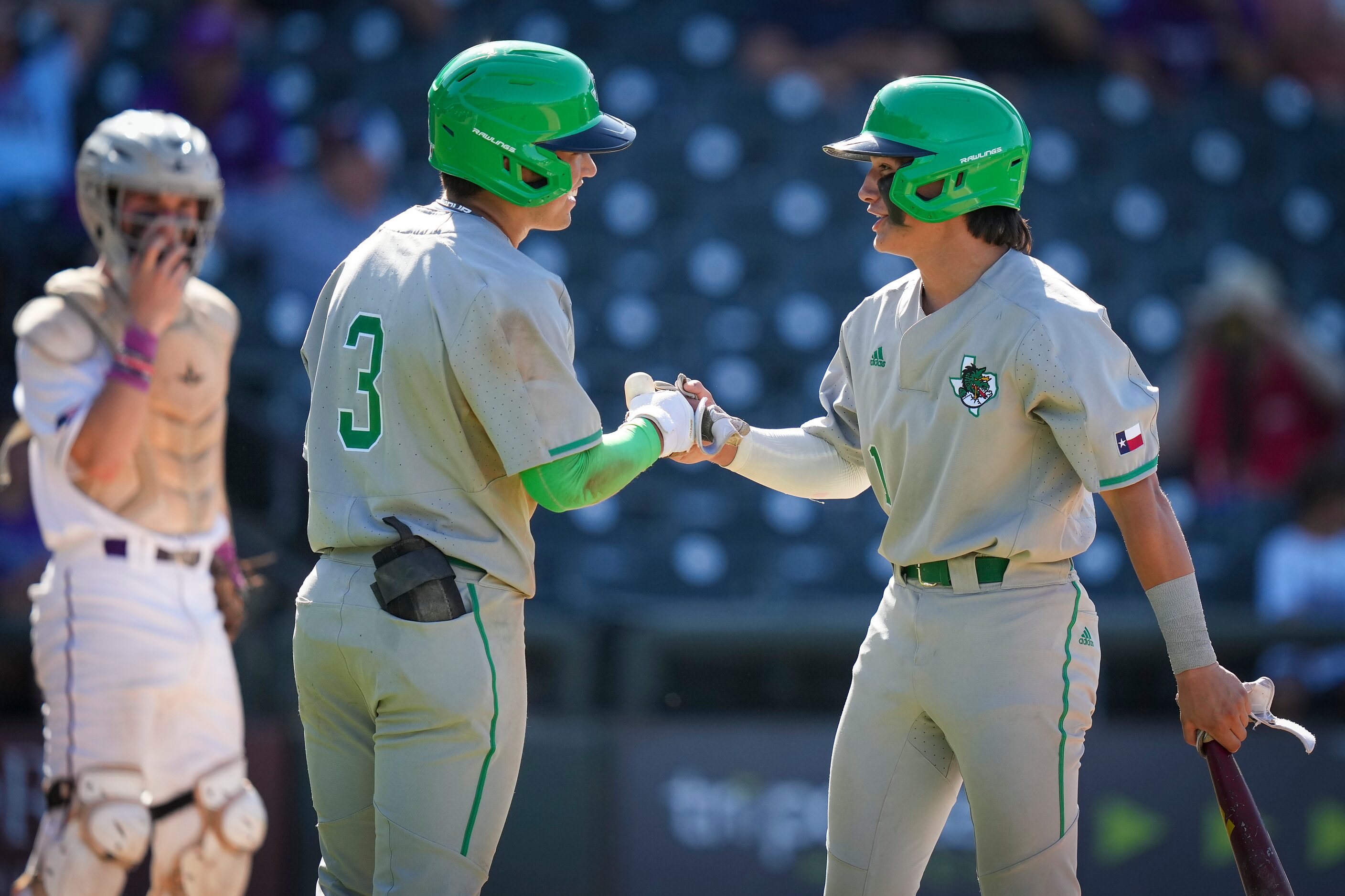 Southlake Carroll shortstop Ethan Mendoza (1) celebrates with left fielder Max Reyes (3)...