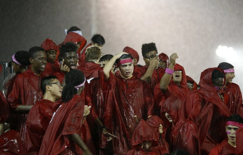 Cedar Hill band dances in the rain in between plays in a game against DeSoto during the...