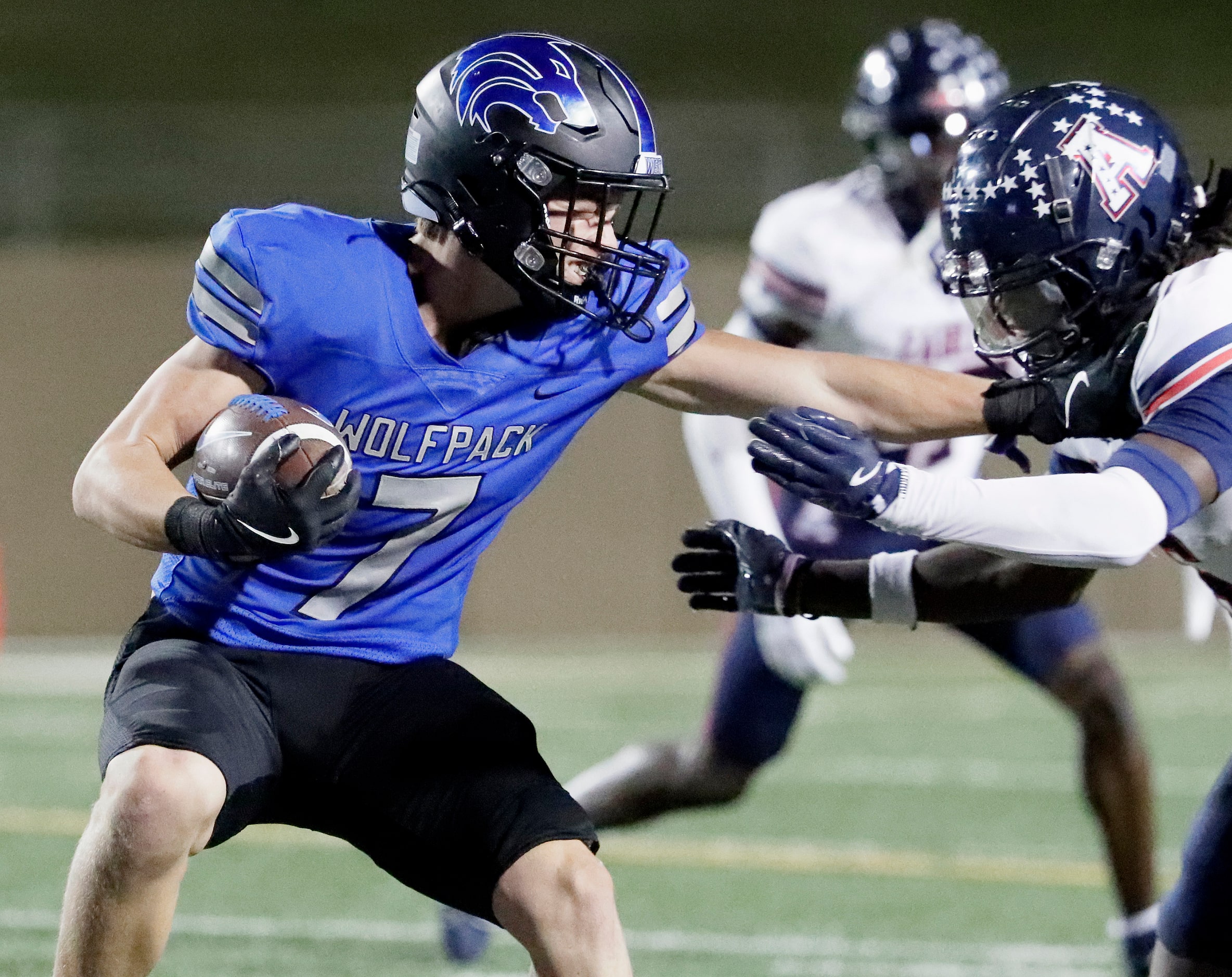 Plano West High School running back Luke Perez (7) stiff arms Allen High School defensive...