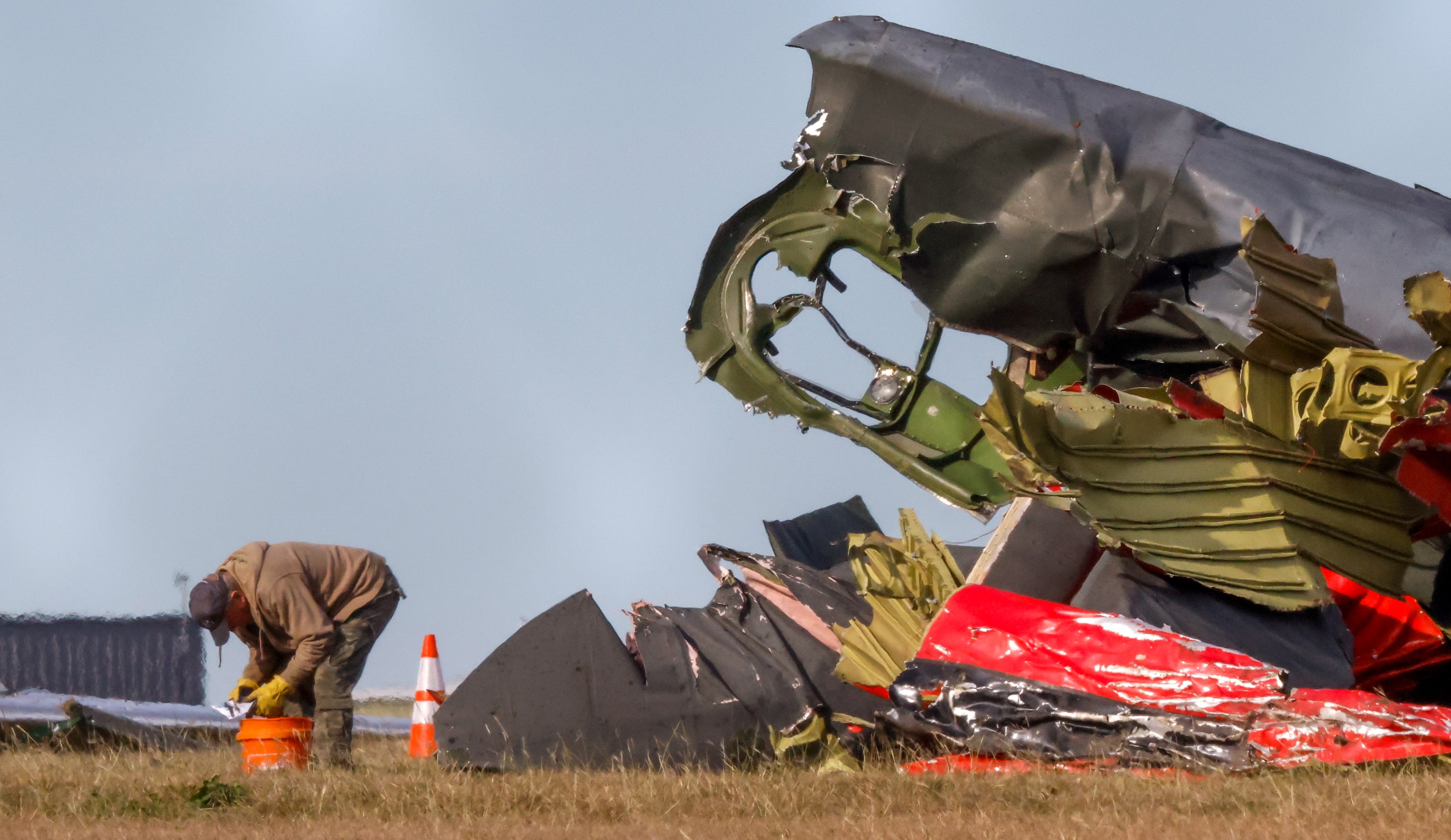 Much of the debris around a damaged plane at the Dallas Executive Airport is removed  on...