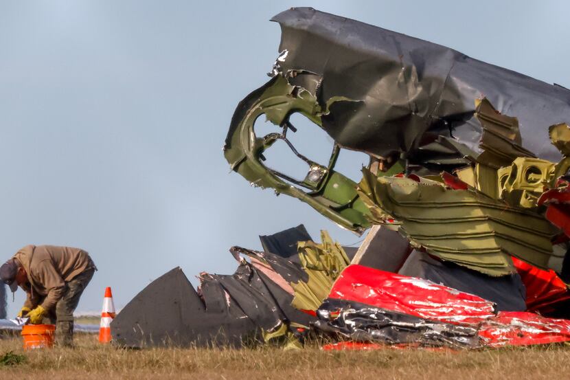 Much of the debris around a damaged plane at the Dallas Executive Airport is removed  on...