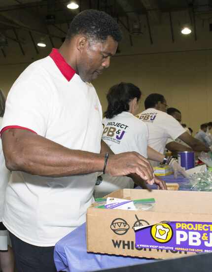 Former NFL player Herschel Walker boxes up PB&J sandwiches towards the end of Which Wich's...
