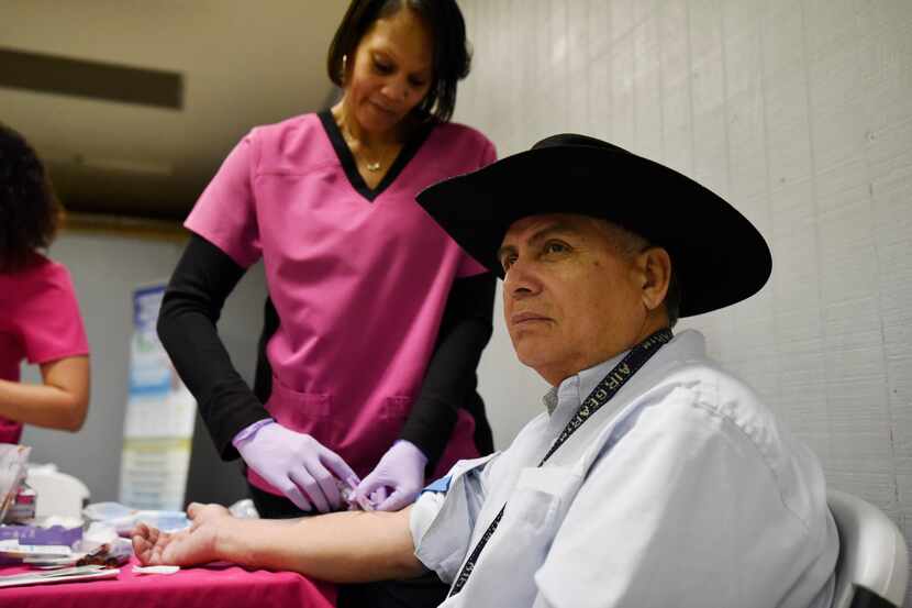 Salvador Cervantes, 63, has his blood collected during a health and safety fair last month...