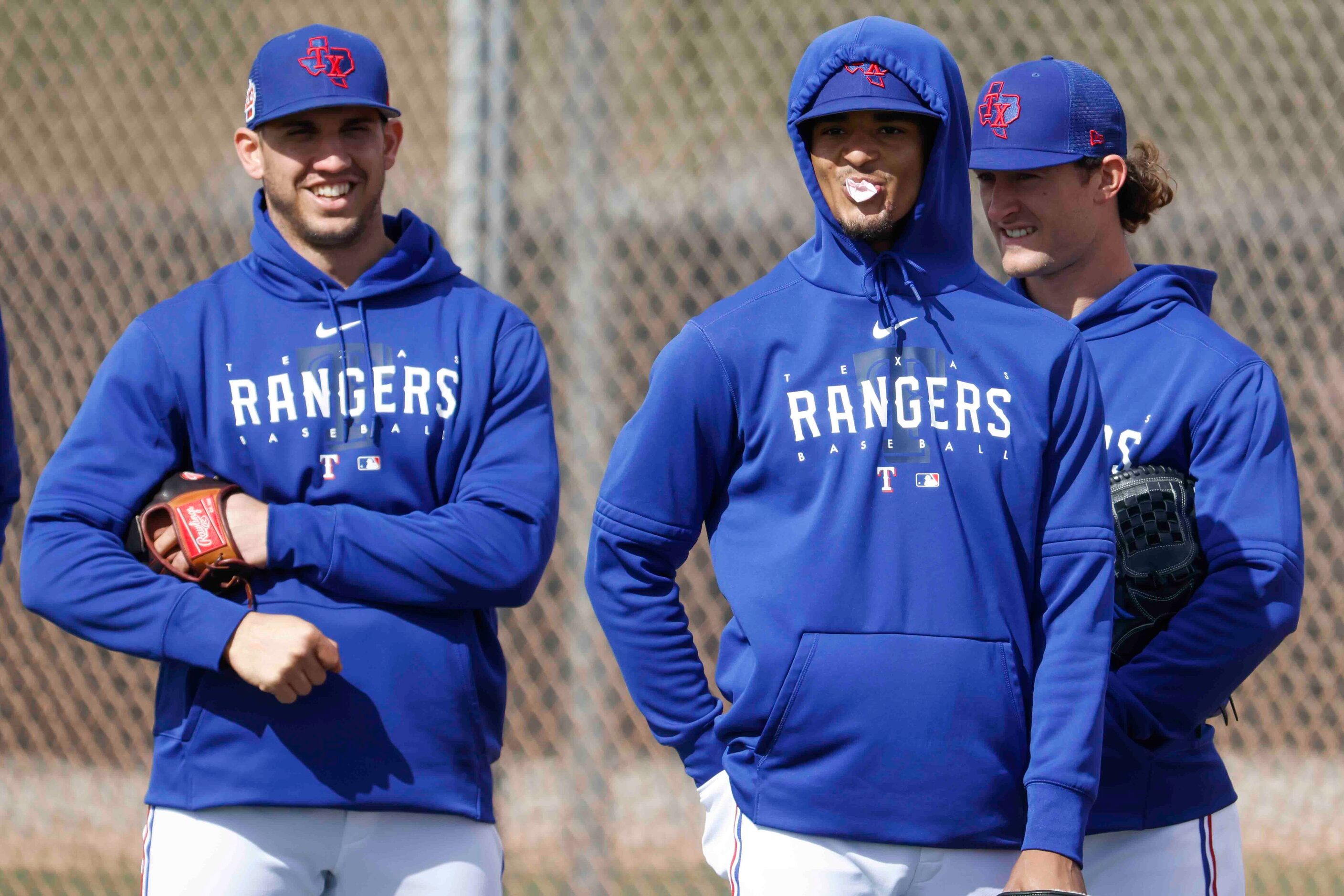 Texas Rangers pitcher Jacob Barnes, left, Marc Church, center, and Jake Latz wait for a...