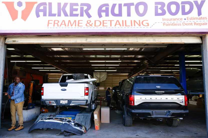 Walker Auto Body & Frame Shop owner Mark Walker Jr. opens up the main entrance of the...