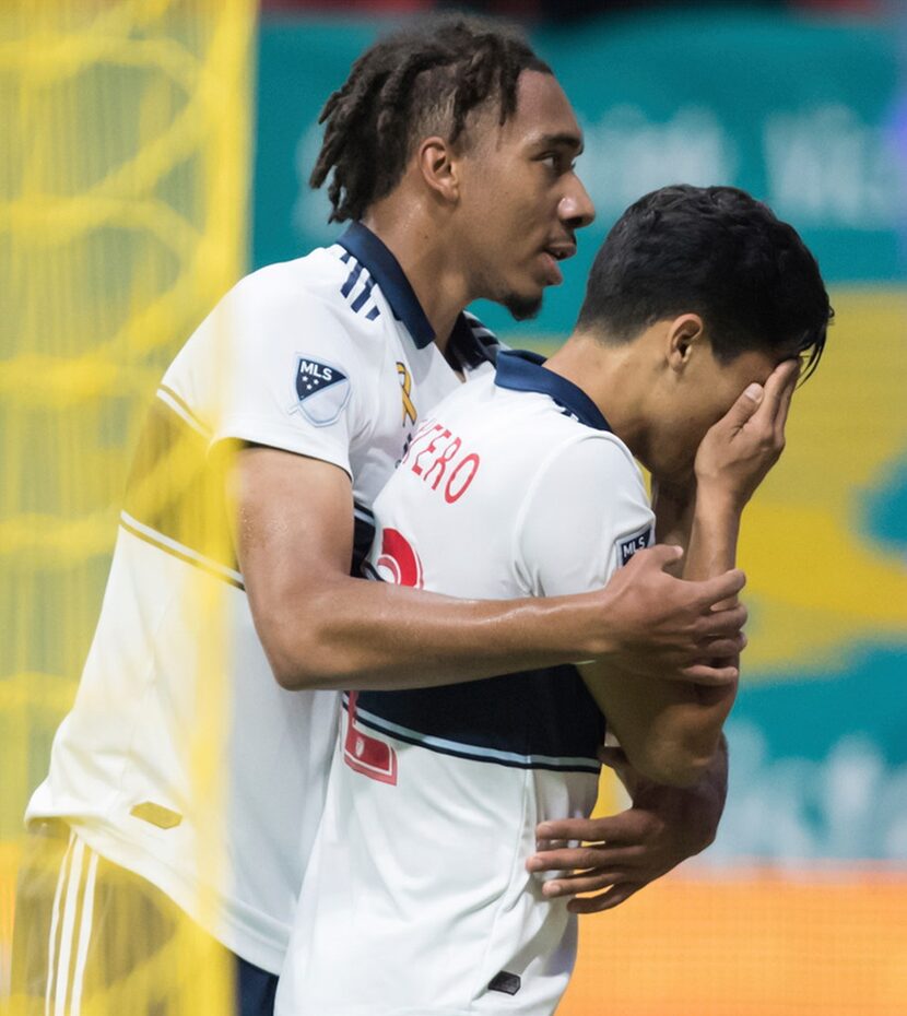 Vancouver Whitecaps' Theo Bair, left, and Fredy Montero celebrate Montero's goal against the...