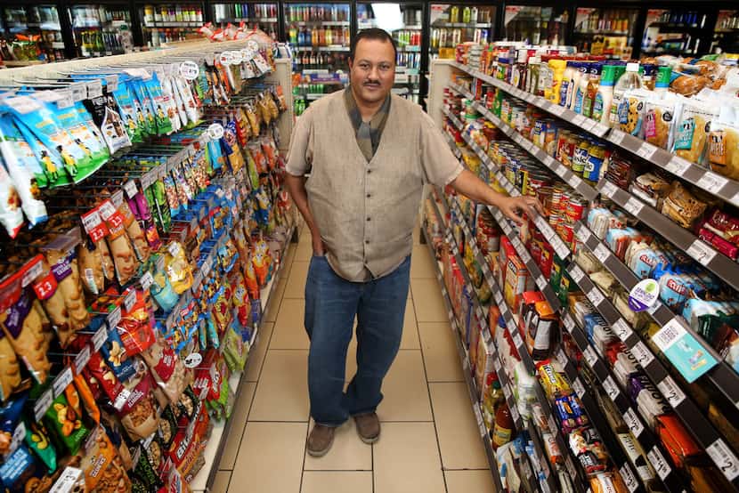 Franchise owner Bekele Tilahun poses for a photograph at his 7-Eleven in downtown Dallas.