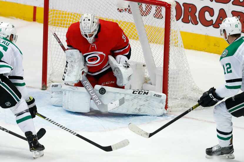 Carolina Hurricanes goaltender Curtis McElhinney (35) defends the goal against Dallas Stars...