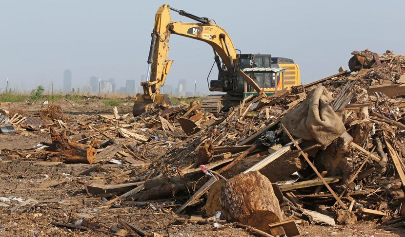 With the downtown Dallas skyline in the background, heavy machinery works in the McCommas...