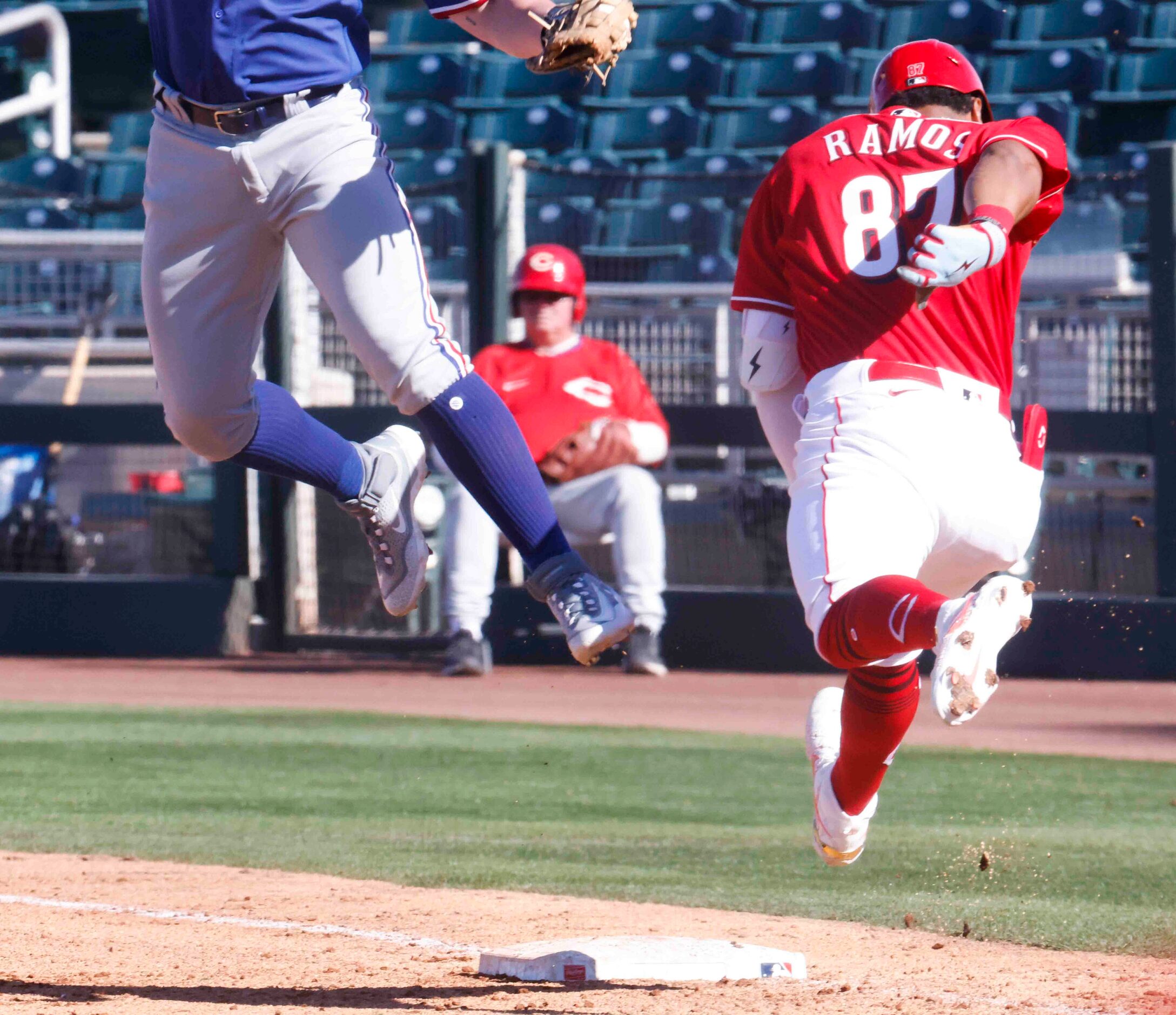 Cincinnati Reds Henry Ramos reaches first base on a throwing error as the ball gets past...