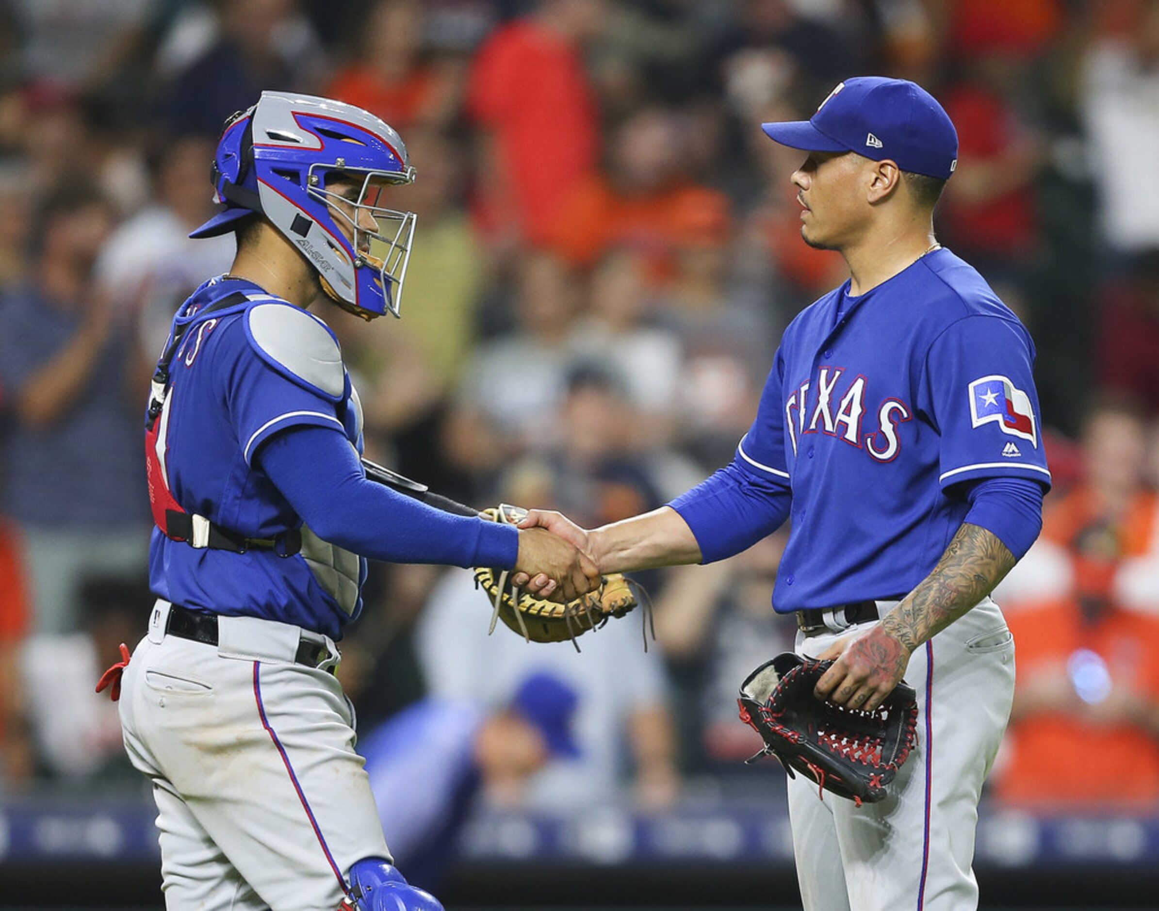 HOUSTON, TX - MAY 11:  Keone Kela #50 of the Texas Rangers shakes hands with Robinson...