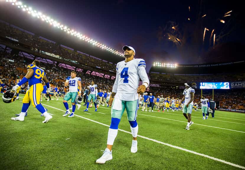 Dallas Cowboys quarterback Dak Prescott (4) walks off the field with fireworks after a 14-10...